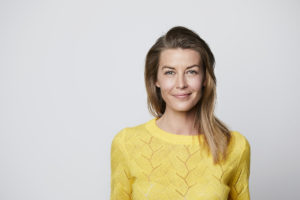 Confident woman in yellow top, portrait