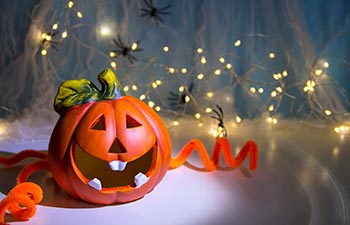 Halloween pumpkin head Jack lantern with burning candles.