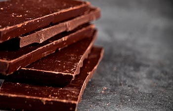 Dark chocolate bar pieces closeup